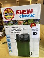 Box showing Eheim Classic 2215 external canister filter with multilingual labeling and 2-year guarantee badge