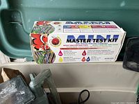 Boxed Master Test Kit for aquarium water testing, showing kit packaging with colorful aquatic images and text