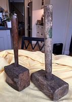 Full view of two primitive wooden mallets side by side showing heads and handles.