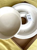 Top view showing the two ceramic molds, one bowl-shaped and one ring-shaped with holes.