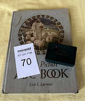 Front cover of the Bible Picture ABC Book with illustration and alphabet circle and the small thumb Bible on top.