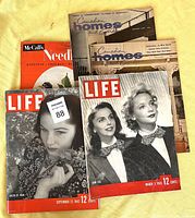 Five vintage magazines arranged flat on a light surface: two Life magazines from 1942 and 1943, two Canadian Homes and Gardens magazines from 1957, and one McCall's Needlework magazine from 1956.