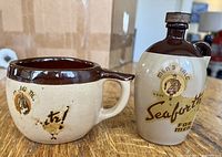 Front view of vintage men’s shaving mug and cologne bottle together on table, showing label and condition.