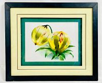 Framed artwork showing the complete piece with outer black frame, cream and green mats highlighting the embroidery art of yellow flowers.