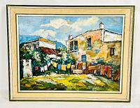 Frontal view of the framed oil painting showing the rustic village scene with detailed houses, laundry lines, and grassy foreground.