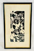 Framed woodblock print with group of stylized people in black and white, signed at bottom.