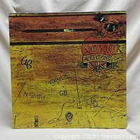 Front cover of Alice Cooper School's Out vinyl record showing illustrated school desk with carved writing and title in red.