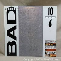 Front cover of Bad Company's 10 From 6 vinyl album showing band name and album title with minimalistic silver/white design.