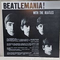Front cover of Beatlemania! With The Beatles vinyl album showing black and white photos of the four Beatles and text with a brief write-up about the Beatles phenomenon.