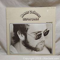 Front cover of Elton John's Honky Chateau album showing black and white portrait with sunglasses.