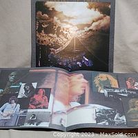 Front cover photo of Jackson Browne's Running on Empty album showing road and cloudy sky artwork. Gatefold open showing black and white performance photos and band members.