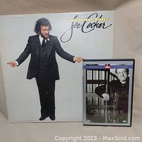 Photo of Joe Cocker vinyl record 'Luxury You Can Afford' and the DVD 'Mad Dogs & Englishmen' showing both items included in the lot.