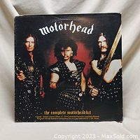 Front cover of Motörhead EP showing band members in studded leather outfits holding weapons with band logo and album title.