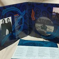 Open gatefold sleeve showing inner artwork and band photos along with printed lyrics.