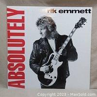 Front cover of the vinyl record album titled Absolutely by Rik Emmett showing artist holding guitar in a leather jacket with bold red text.