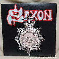 Front cover of Saxon Wheels of Steel vinyl showing the band logo and emblem design.