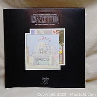 Front cover of the vinyl album showing the title 'The Soundtrack From the Film Led Zeppelin - The Song Remains the Same' with stylized building artwork.