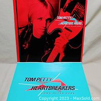 Front cover of Tom Petty and the Heartbreakers Long After Dark vinyl record album showing Tom Petty holding guitar with red and black design.
