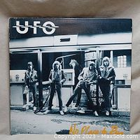 Front cover of the UFO 'Nowhere to Run' vinyl album showing band members at gas pumps in black and white with the band name and album title.
