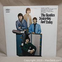 Front cover of the vinyl LP album showing four band members posing around and on an amplifier. The title "The Beatles Yesterday And Today" is printed on the cover.