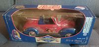 Front view of the diecast replica car in its original box showing red and blue Pepsi-Cola themed 1940 Ford car and clear display window.