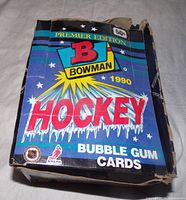 Full unopened blue box of 1990 Bowman Premiere Edition hockey card packs showing wear and tear