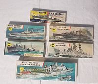 Six boxed Airfix 600 scale ship model kits arranged showing box art with ship illustrations.