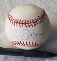 Baseball signed by Roberto Alomar in blue ink showing signature clearly.