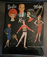 Front cover of the black carrying case showing vintage styled artwork of Barbie, Ken, and Midge dolls.