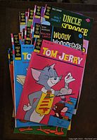 Stack of 20 Gold Key comics from the 1970s showing covers of Tom and Jerry, Woody Woodpecker, Uncle Scrooge, and others.