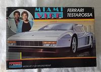 Box for the Monogram Miami Vice Ferrari Testarossa 1/24 scale car model kit, featuring artwork of a white Ferrari Testarossa with Miami Vice show characters inset on the upper left corner