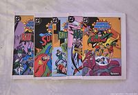 Photo of five mini comic books fanned out showing the front covers featuring Batman, Superman, Green Lantern, Hawkman, and Robin the Teen Wonder, all from the Kenner Super Powers series in good used condition.