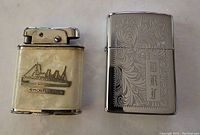 Photo of two vintage lighters: one Zippo with ornate engraving and initials DRT, one Kwick lighter with ship emblem and pearlescent body