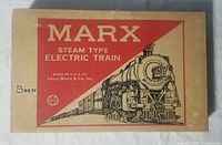 Photo of the original cardboard box for the Marx Steam Type Electric Train set, featuring red and beige design and steam locomotive graphic.