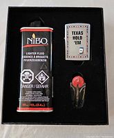 Original box containing Zippo lighter with WPT Texas Hold 'Em logo, NiBO lighter fluid can, and red black flint dispenser.