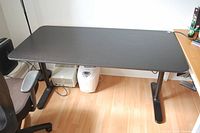 Full top view of the black IKEA Bekant adjustable height desk showing the rectangular surface and black legs.