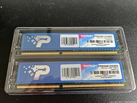 Two Patriot PSD34G1333KH DDR3 4GB RAM sticks in plastic clamshell packaging, showing label details and overall condition.