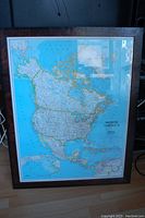 Front view of the professionally framed National Geographic map showing detailed political boundaries and geographical features of North America.