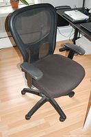 Front and angled view of black mesh Tempur-Pedic office chair showing padded seat and armrests on a five-star caster base