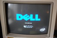 Monitor screen powered on showing Dell boot screen with Intel logo, demonstrating working condition.