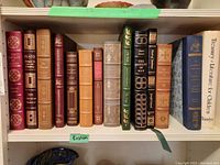 Front view of entire shelf of leather-bound books