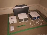 Group shot of one large ZonePlayer S5, two medium amplifiers with top perforations, one Connect with RCA cables attached and one small Bridge unit