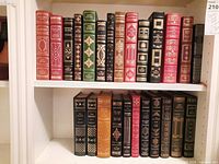 Two shelves of leather-bound books showing full lot