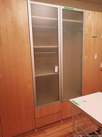Front view of cabinet with both frosted glass framed doors closed