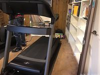 Angled side view of treadmill frame and running belt
