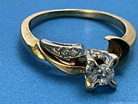 Front-facing view of ring showing central diamond and accent stones