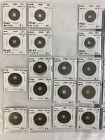 Four pages of slabbed antique Asian coins from Korea arranged in plastic sleeves with handwritten labels showing date, denomination, and condition.