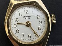 Front dial close-up showing ‘Bentina star’ logo, gold hands and Arabic numerals on white background