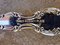 Close-up of flatware handle stamped “BIRKS REGENCY PLATE”
