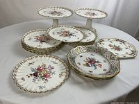 All 17 pieces including cake stands, dinner plates and serving plates arranged on table
